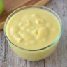 A creamy apple delight puree in a glass bowl, perfect for babies starting on solid foods.