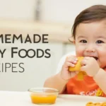 A happy baby enjoying homemade baby food with a fresh puree and finger food, promoting healthy eating habits.